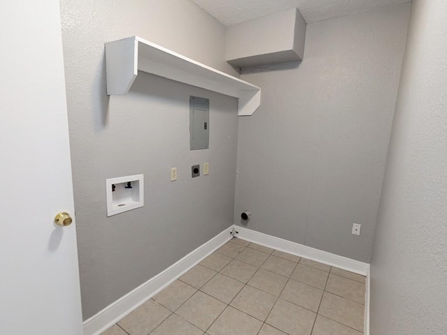 laundry area with baseboards, washer hookup, laundry area, light tile patterned flooring, and hookup for an electric dryer