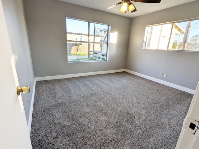 empty room featuring baseboards, carpet floors, and ceiling fan