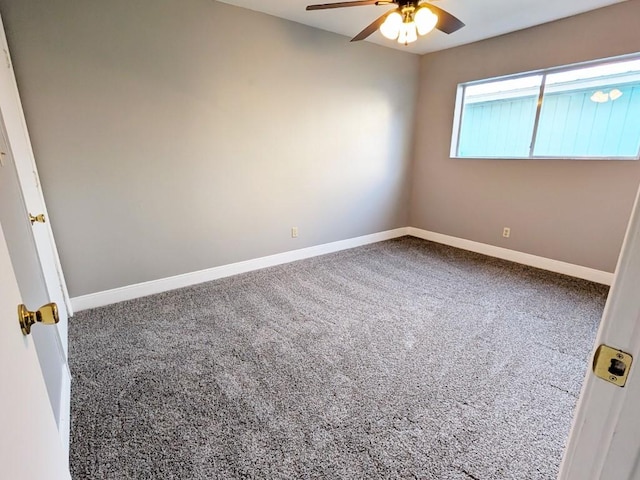 carpeted empty room featuring a ceiling fan and baseboards