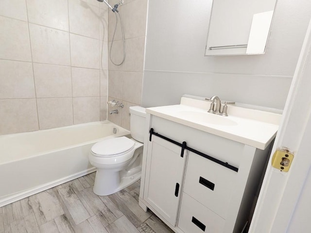 full bathroom featuring toilet, vanity, bathtub / shower combination, and wood finished floors