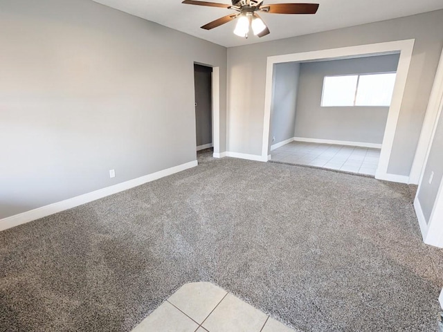 unfurnished bedroom with carpet flooring, a ceiling fan, and baseboards