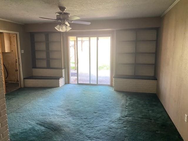 carpeted empty room with a ceiling fan and a textured ceiling