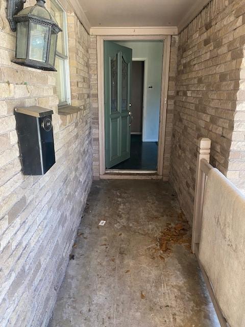 doorway to property featuring brick siding