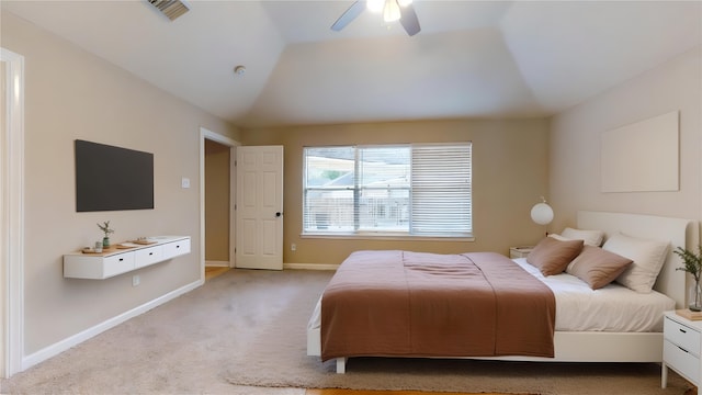 bedroom featuring visible vents, light carpet, baseboards, ceiling fan, and vaulted ceiling