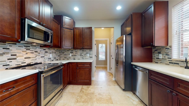 kitchen with a sink, appliances with stainless steel finishes, and light countertops