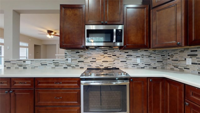 kitchen with light countertops, tasteful backsplash, appliances with stainless steel finishes, and ceiling fan