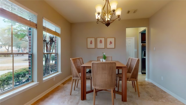 dining area with visible vents, a notable chandelier, a healthy amount of sunlight, and baseboards