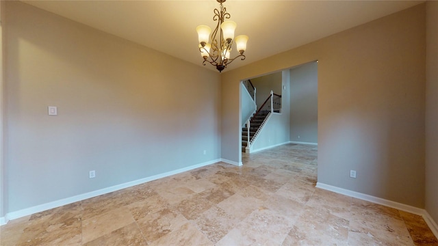 empty room featuring baseboards, a notable chandelier, and stairs