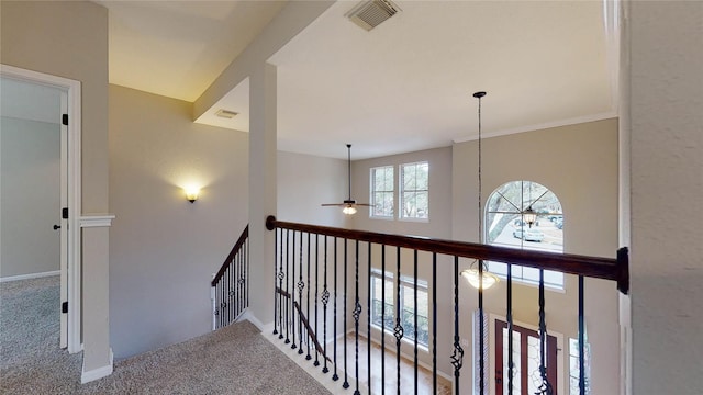 corridor featuring visible vents, an upstairs landing, baseboards, and carpet flooring