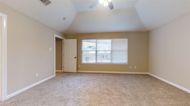 empty room with visible vents, ceiling fan, baseboards, carpet, and lofted ceiling