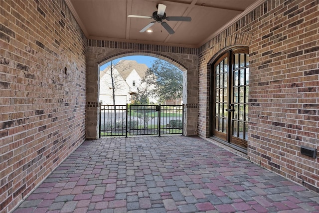 view of patio with a gate, french doors, fence, and ceiling fan