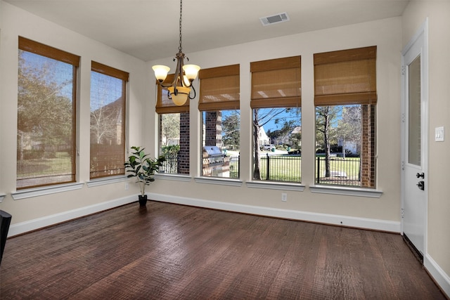 unfurnished dining area with plenty of natural light, baseboards, and visible vents