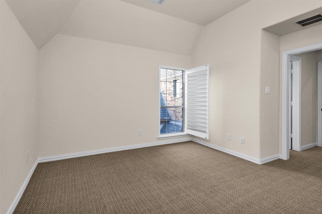 carpeted empty room with visible vents, baseboards, and lofted ceiling