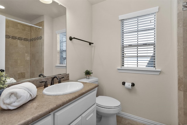 full bathroom featuring vanity, tile patterned floors, toilet, and a healthy amount of sunlight