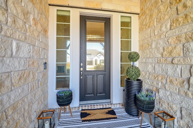 entrance to property featuring stone siding