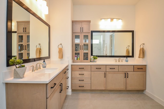 full bath with tile patterned flooring, two vanities, and a sink