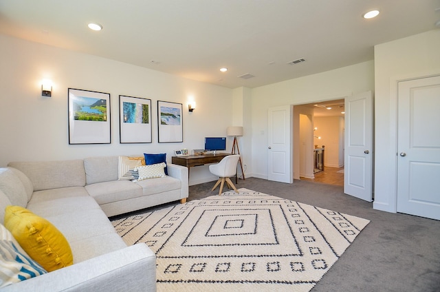 carpeted living area with recessed lighting, visible vents, and baseboards