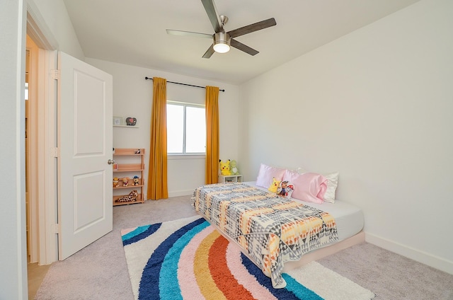 carpeted bedroom with baseboards and a ceiling fan