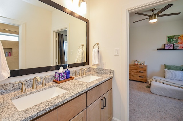 bathroom featuring double vanity, ceiling fan, and a sink