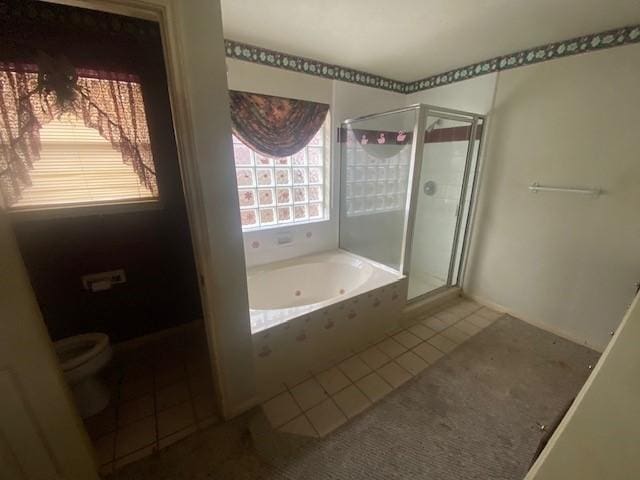 bathroom with tile patterned floors, a stall shower, toilet, and a garden tub