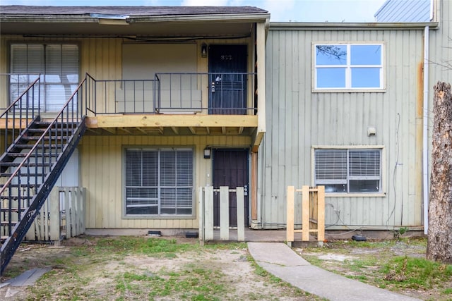 exterior space with stairs and a balcony