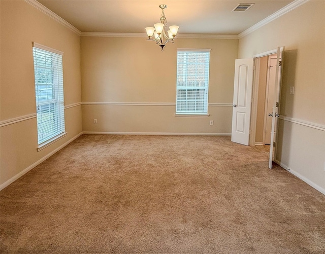 carpeted empty room with visible vents, baseboards, an inviting chandelier, and ornamental molding