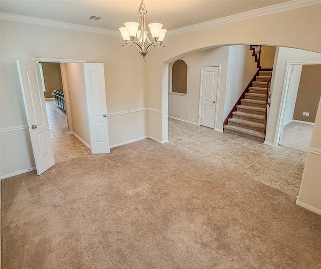 spare room with visible vents, carpet, stairs, ornamental molding, and arched walkways