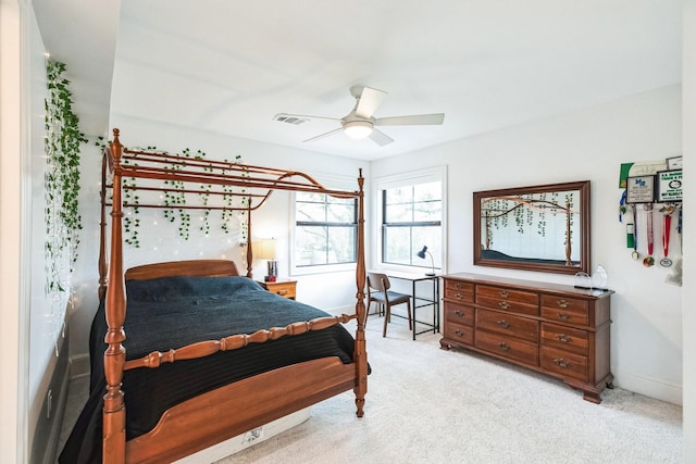 bedroom featuring a ceiling fan, baseboards, visible vents, and light carpet