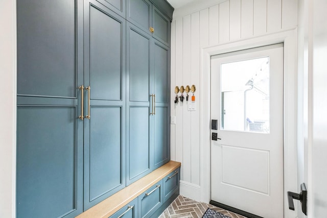 mudroom featuring brick floor