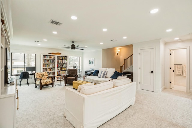 living room with plenty of natural light, light colored carpet, and visible vents