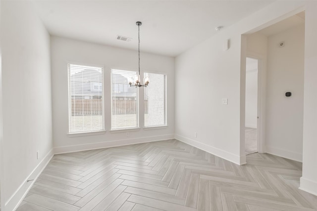 unfurnished dining area featuring an inviting chandelier, baseboards, and visible vents