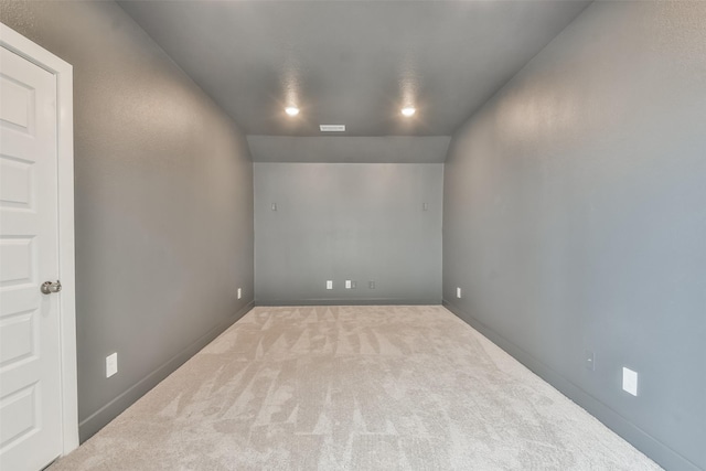 spare room featuring visible vents, baseboards, and carpet