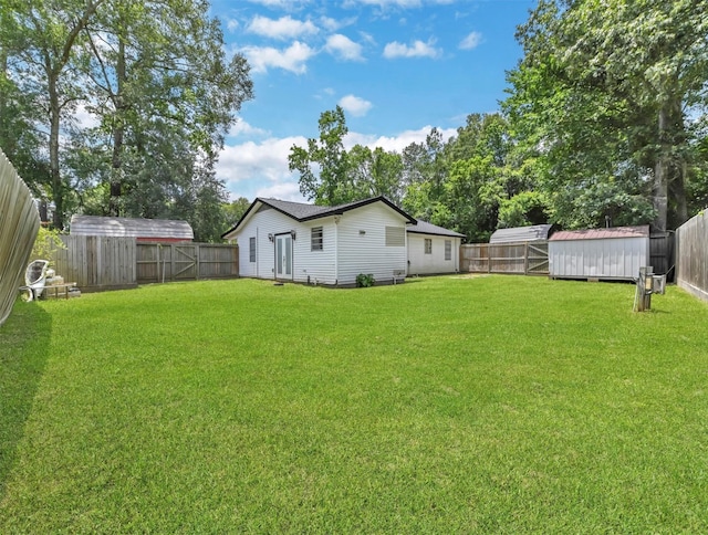 view of yard with an outbuilding and a fenced backyard