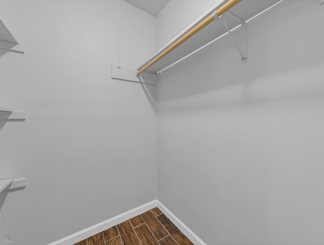 walk in closet featuring wood finish floors