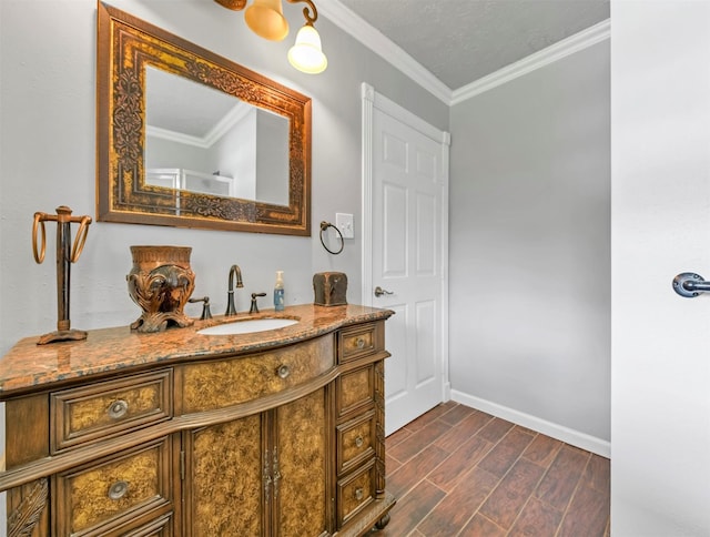 bathroom featuring ornamental molding, vanity, baseboards, and wood tiled floor