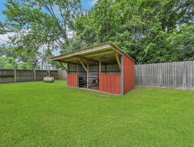 view of pole building with a yard and a fenced backyard