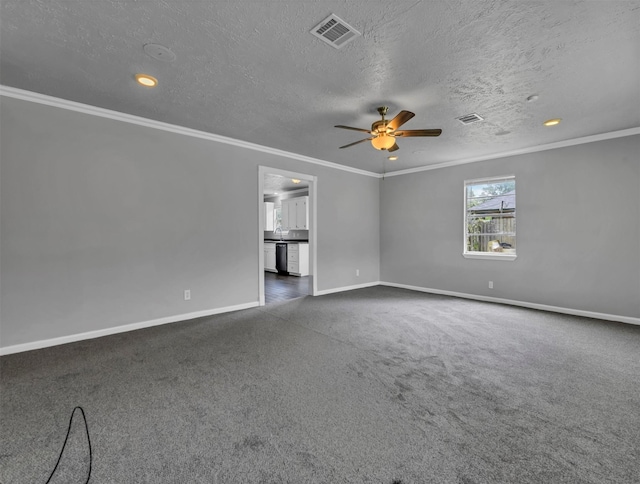 empty room with visible vents, dark carpet, and crown molding