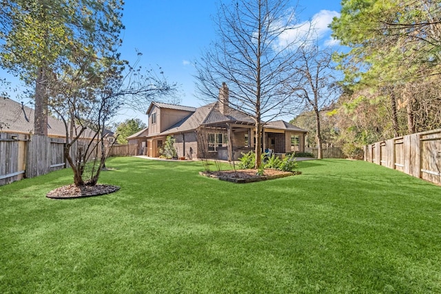 view of yard featuring a fenced backyard