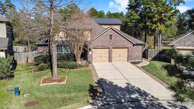 traditional home featuring brick siding, a front lawn, and fence