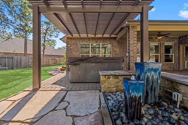 view of patio / terrace featuring a pergola, a hot tub, a ceiling fan, and fence