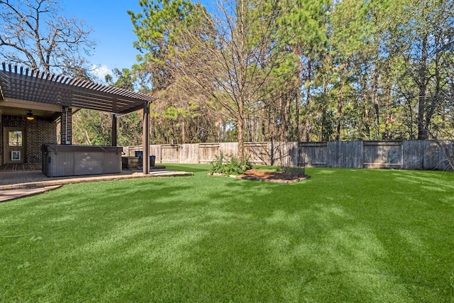 view of yard with a fenced backyard, a pergola, and a hot tub