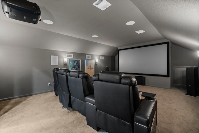 cinema room with visible vents, light carpet, and lofted ceiling