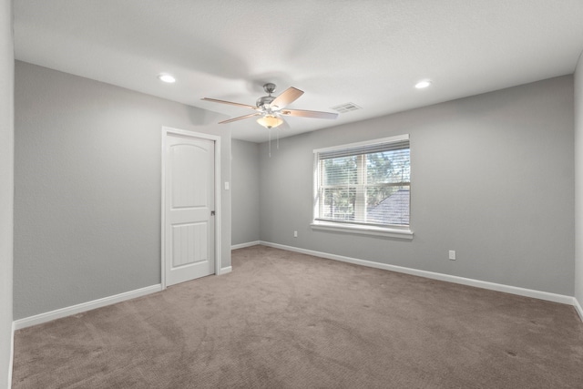 empty room with visible vents, a ceiling fan, recessed lighting, carpet flooring, and baseboards