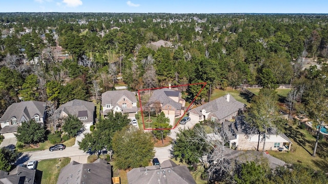 aerial view featuring a forest view and a residential view