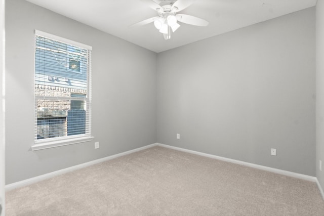 unfurnished room featuring baseboards, carpet, and ceiling fan