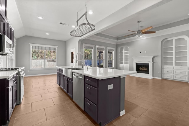 kitchen featuring built in shelves, visible vents, appliances with stainless steel finishes, and a sink