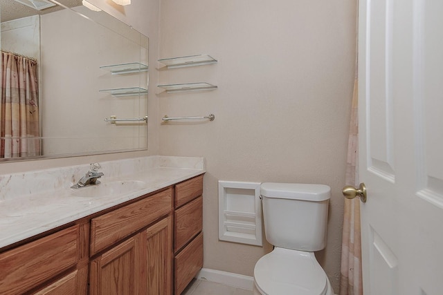 bathroom with tile patterned floors, toilet, and vanity