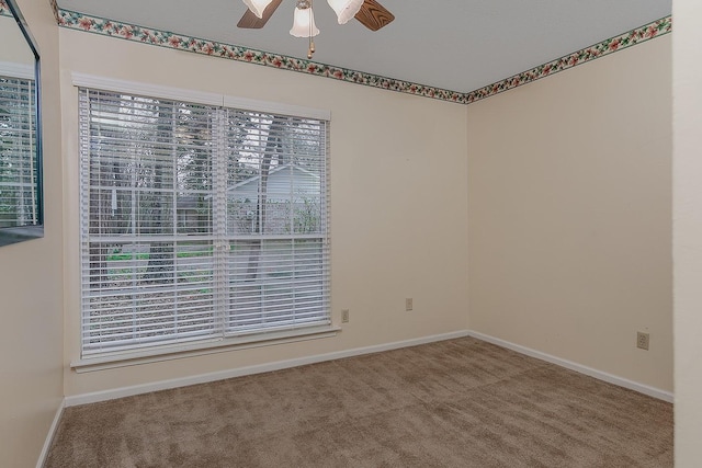 spare room featuring carpet flooring, a ceiling fan, and baseboards