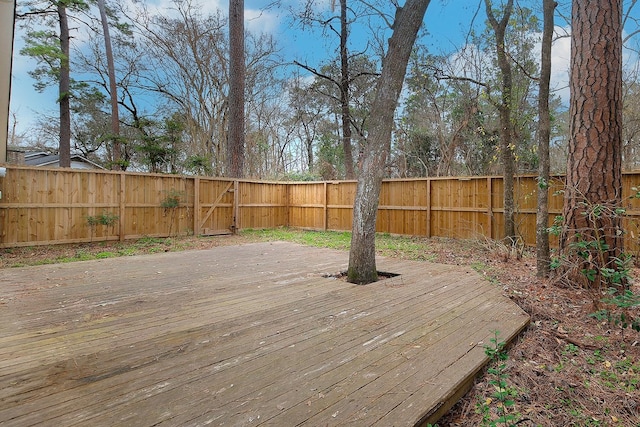 wooden terrace featuring a fenced backyard