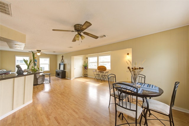 dining room featuring plenty of natural light, light wood-style floors, and visible vents